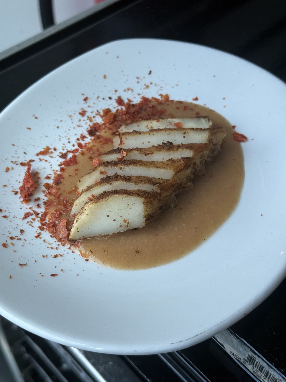 A vegan celeriac dish with celeriac sauce and tomato skin flakes, plated à la minute